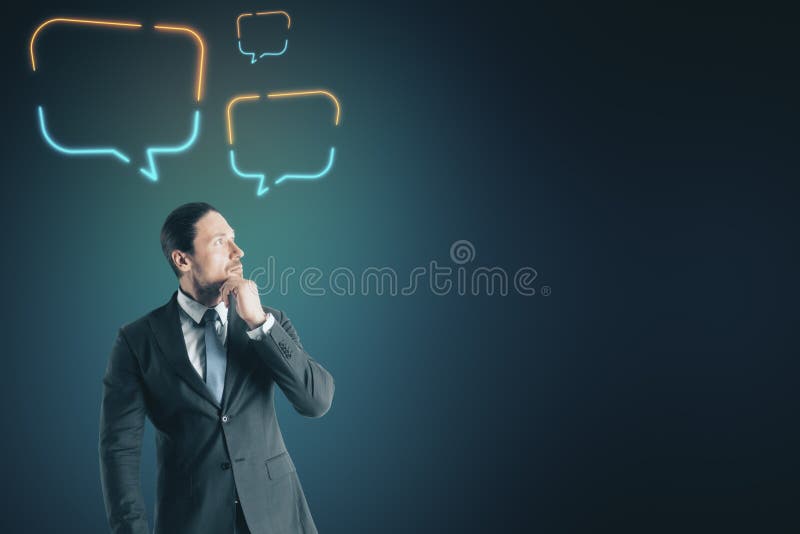 Attractive young businessman with speech balloons royalty free stock photos
