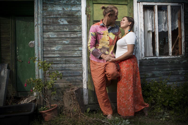 Attractive young couple at wooden house