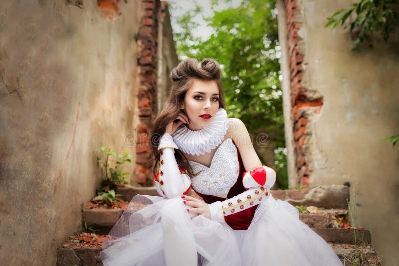 Attractive young girl dressed as red queen medievel costume