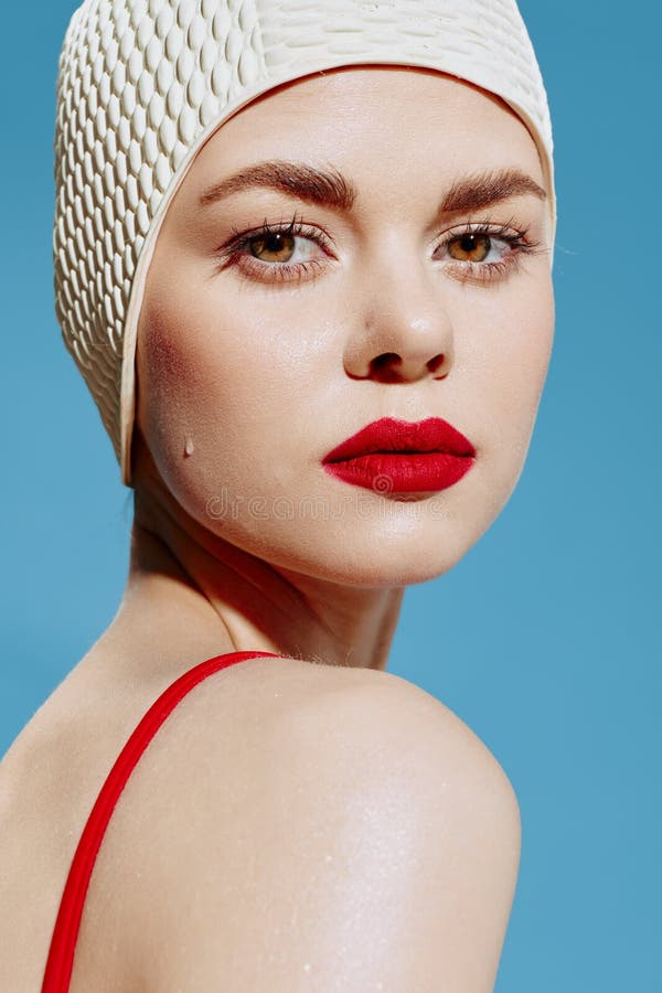 An Attractive Young Girl In A Swimming Cap With Drops Of Water On Her