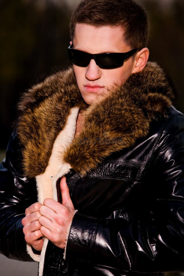 Attractive young guy in winter leather jacket