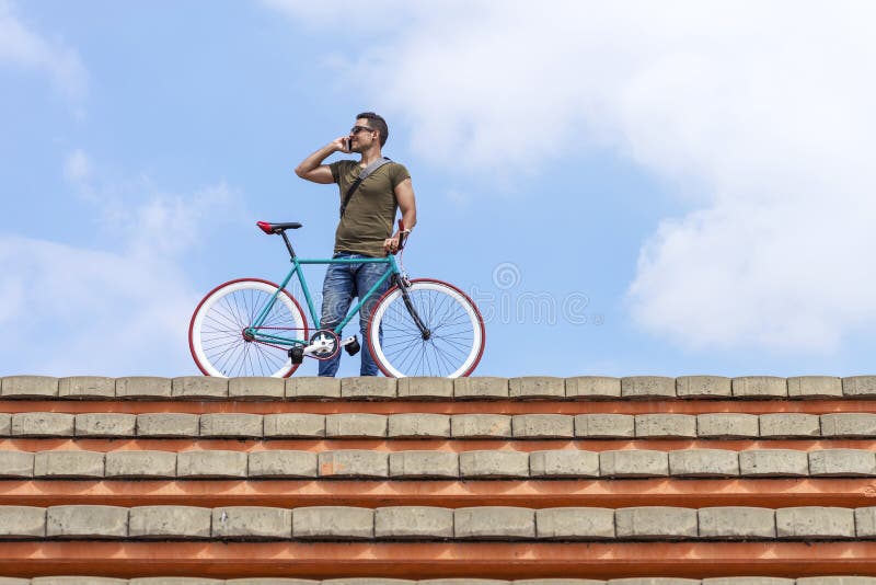 Attractive young man standing outdoors and calling on the phone royalty free stock photos Attractive young man standing outdoors and calling on the phone royalty free stock photos