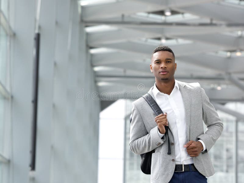 Attractive young man walking with bag