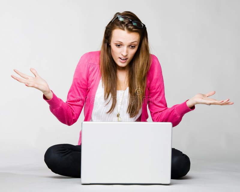 Attractive young woman angry with her laptop stock images