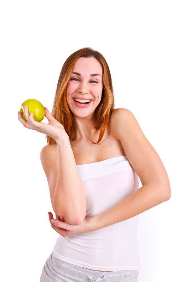 Attractive young woman with apple laughing