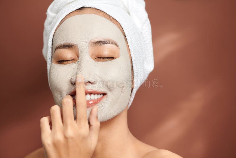 Attractive Young Woman Applying Cosmetic Mask on Her Face Stock Photo ...