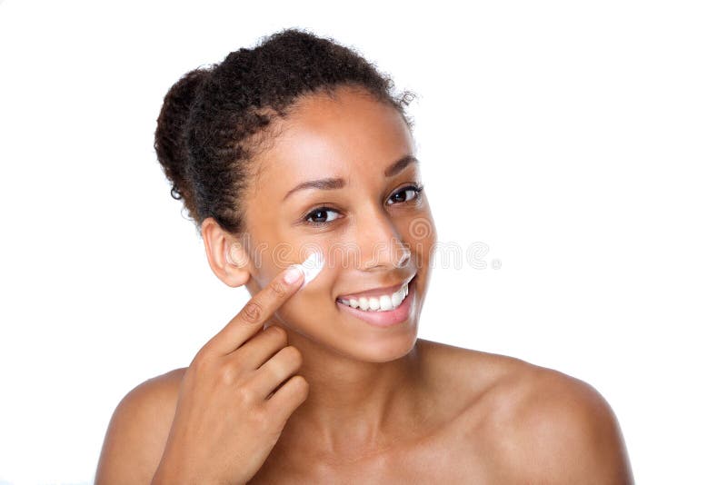 Attractive young woman applying cream on face stock photography Attractive young woman applying cream on face stock photography