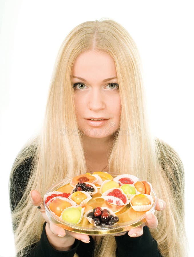 Attractive young woman with fruit candies