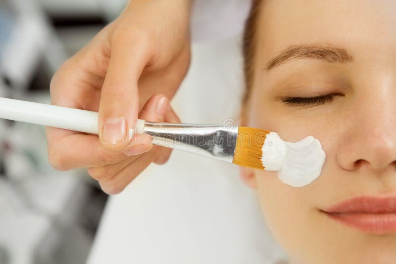 Attractive young woman getting facial mask at the spa royalty free stock images Attractive young woman getting facial mask at the spa royalty free stock images