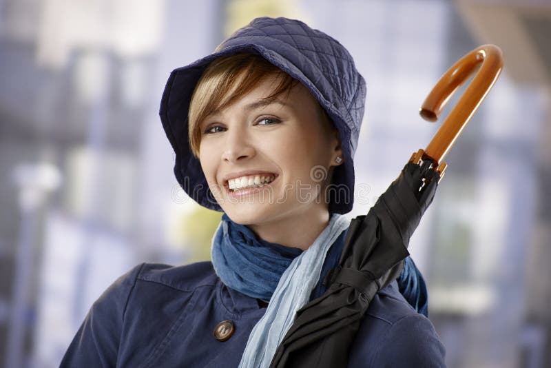 Attractive young woman holding umbrella