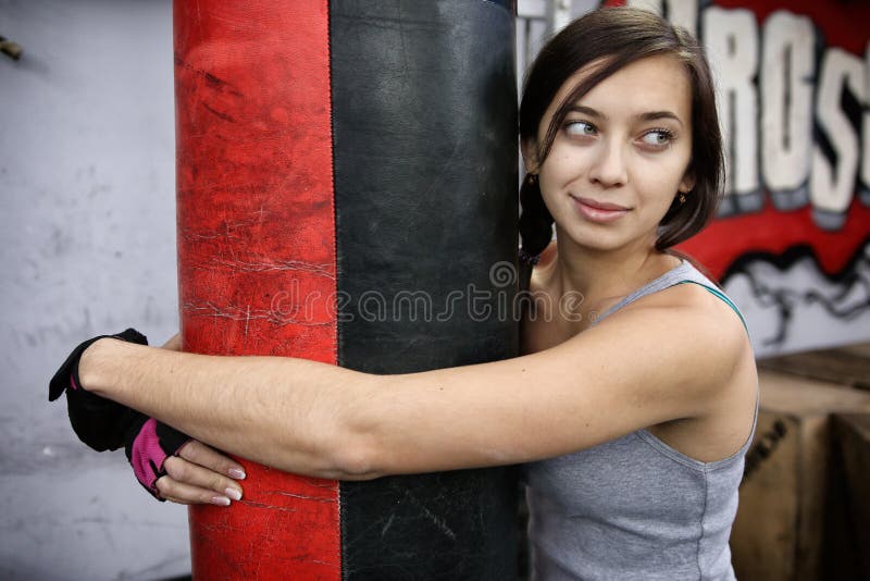 Attractive Young Woman Hugging Punching Bag Stock Image Image of
