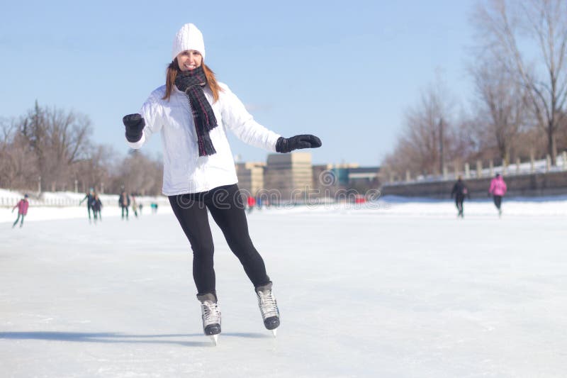 Attractive young woman ice skating during winter stock photography Attractive young woman ice skating during winter stock photography