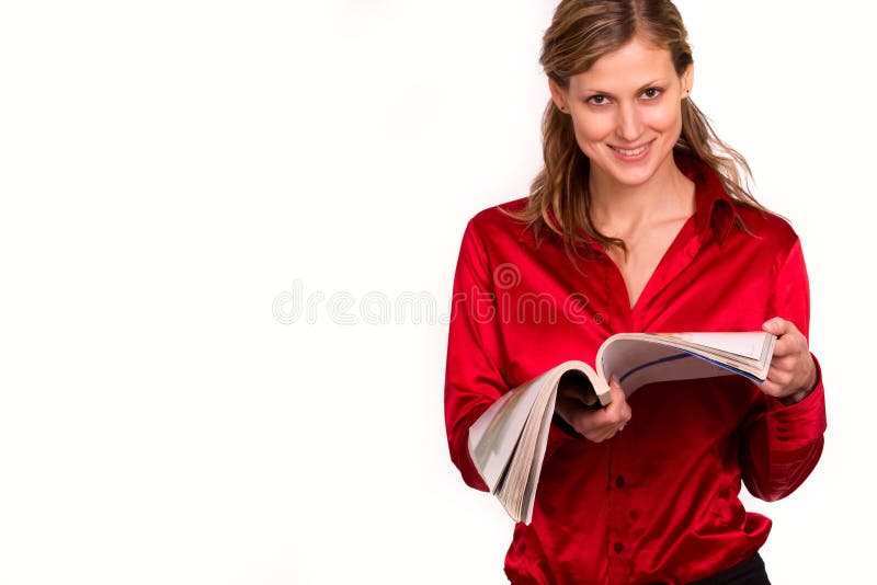 Attractive young woman reading magazine