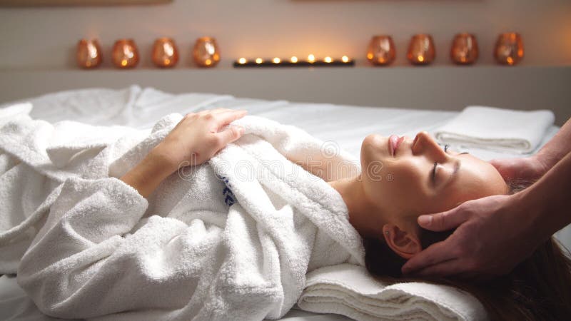 Attractive Young Woman Receiving Head Massage At Spa Center Stock