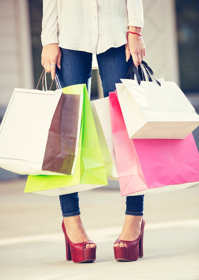 Attractive young woman shopping at the mall standing with bags. Attractive young woman shopping at the mall standing with bags