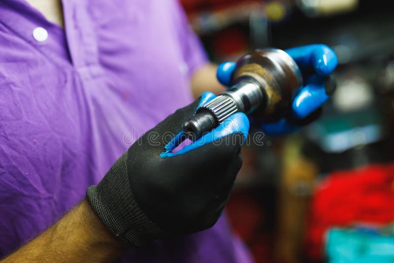 ATV Constantvelocity CV Joint, Repair by Hands Stock Photo Image of