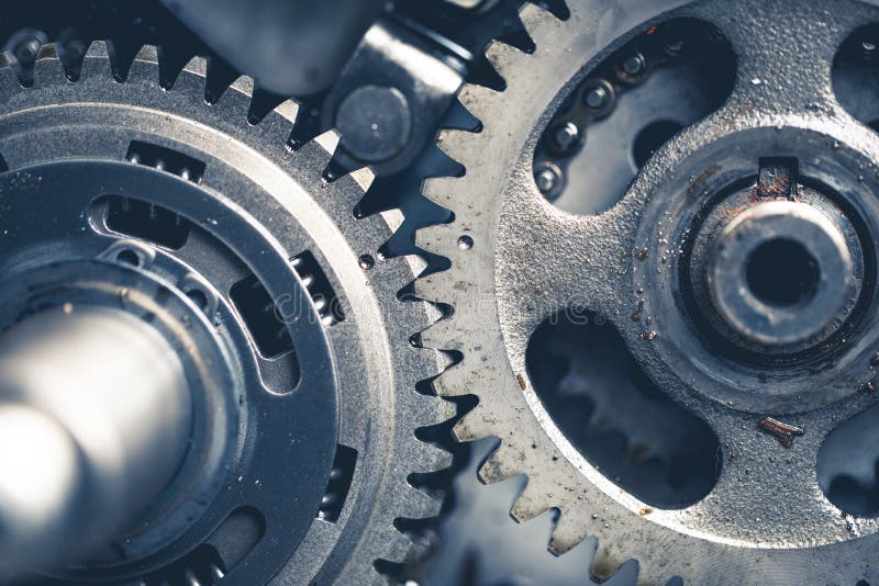 Atv engine gears with oil traces and dirt, disassembled for repairing and maintenance, close-up view