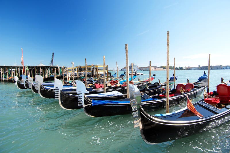 The Grand Canal as a beautiful backdrop of gleaming Gondolas moored for the evening. The Grand Canal as a beautiful backdrop of gleaming Gondolas moored for the evening.