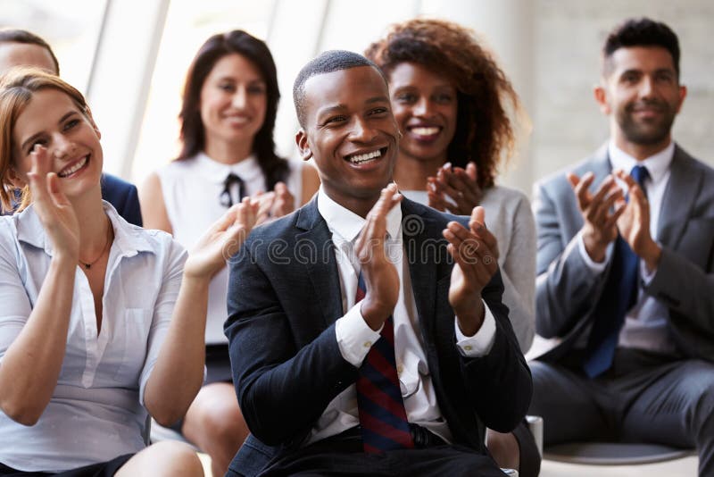 Audience Applauding Speaker At Business Conference