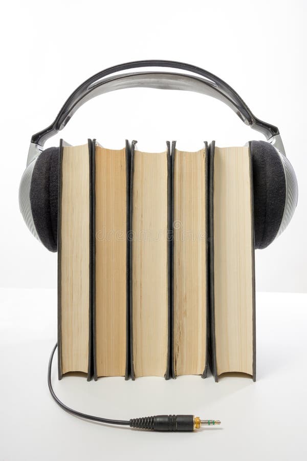 Audio Book Stack of Hardback Books and Electronic Reader. Electronic