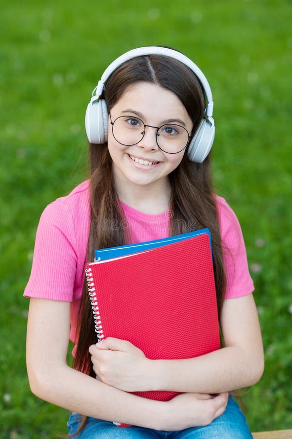 Audio listening and study. Happy child enjoy listening to music. Small girl practise listening skills. Listening course royalty free stock photos