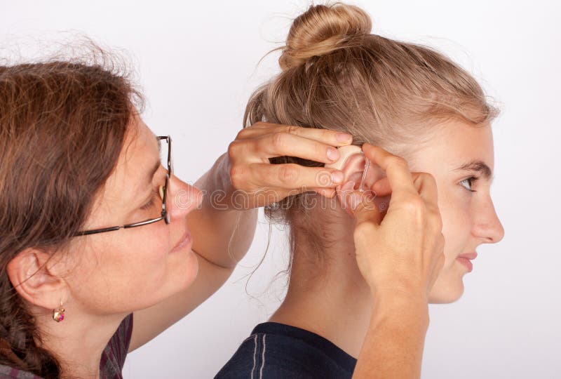 Audiologist and her patient with hearing aid