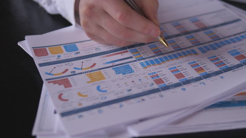 The auditor's close hand checks the financial report stock video