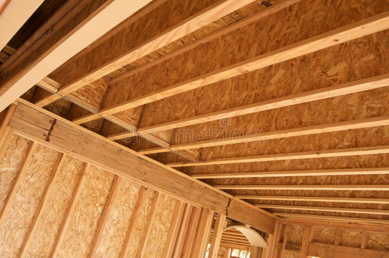 New residential construction home framing against a deep blue sky. New residential construction home framing against a deep blue sky.