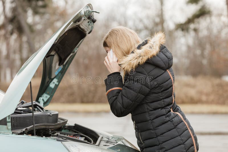 Accident and breakdowns with auto concept. Broken down car, blonde woman having problem, calling to somebody for help. Accident and breakdowns with auto concept. Broken down car, blonde woman having problem, calling to somebody for help.