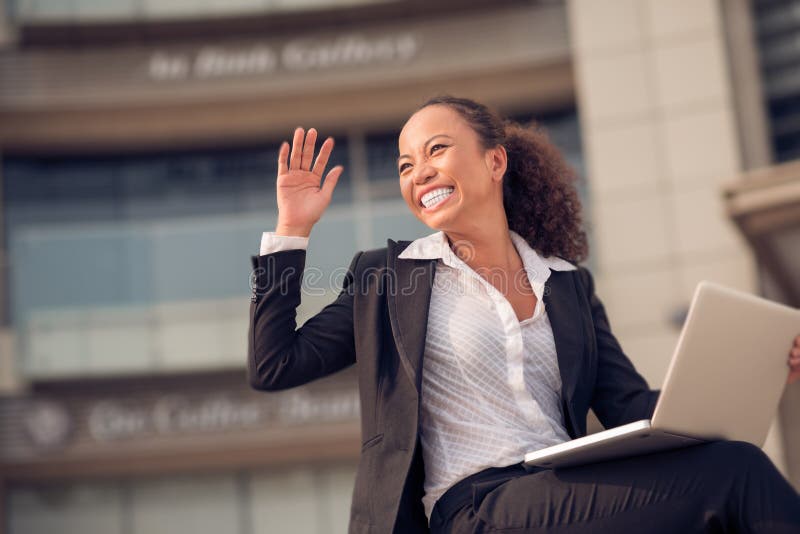 Excited Asian business woman with a laptop outdoors. Excited Asian business woman with a laptop outdoors