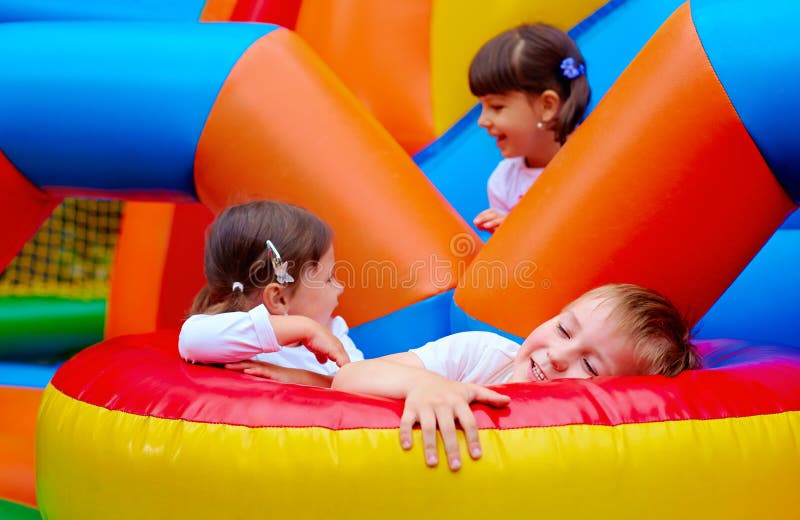 Group of excited kids having fun on inflatable attraction playground. Group of excited kids having fun on inflatable attraction playground