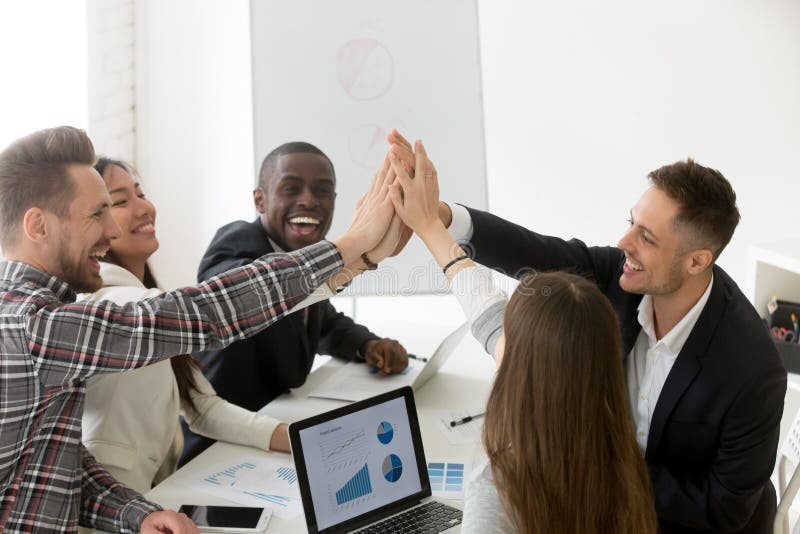 Excited diverse millennial group giving high five celebrating online business win or shared goal achievement, colleagues congratulating with good result, performing team building. Rewarding concept. Excited diverse millennial group giving high five celebrating online business win or shared goal achievement, colleagues congratulating with good result, performing team building. Rewarding concept