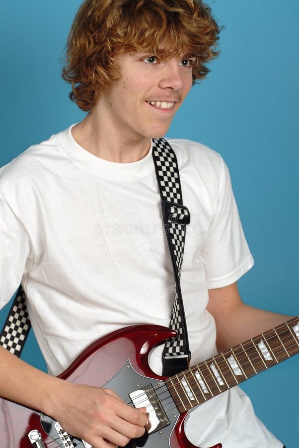 Excited and happy teenager rocking out on his electric guitar. Excited and happy teenager rocking out on his electric guitar