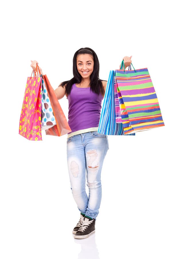 Excited shopping girl with lot of bags in hands, standing on white background. Excited shopping girl with lot of bags in hands, standing on white background