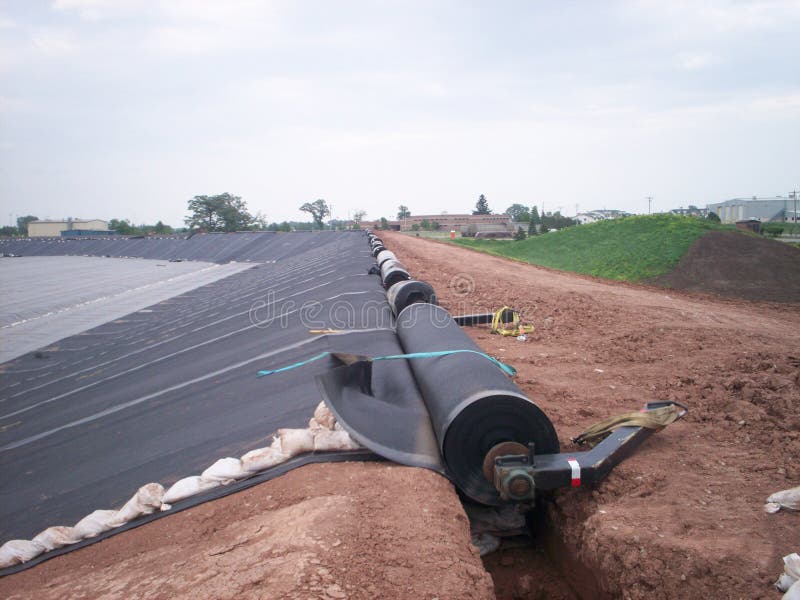 60 mil HDPE Liner for new landfill cell construction. Anchor trench can be seen in this picture. 60 mil HDPE Liner for new landfill cell construction. Anchor trench can be seen in this picture.