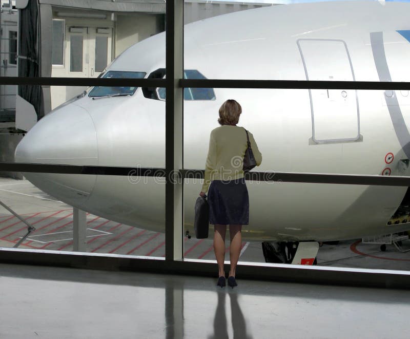 Businesswoman waits for her flight to board. Businesswoman waits for her flight to board