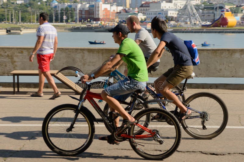 August 7, 2016: Three cyclists ride along the promenade stock photos August 7, 2016: Three cyclists ride along the promenade stock photos