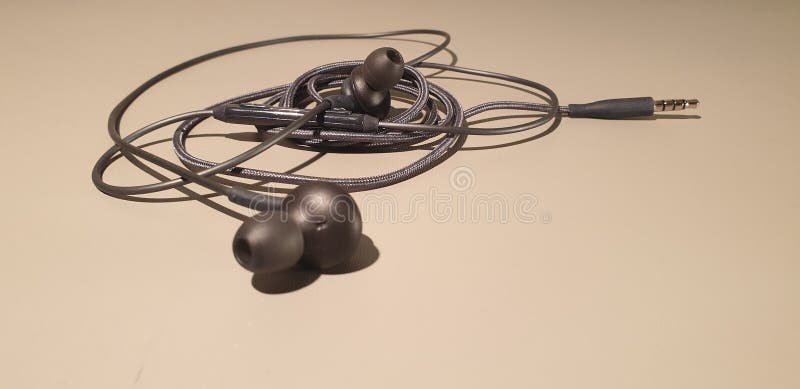 Auriculares atados con alambre Auriculares móviles de las auriculares Enchufes de los auriculares fotografía de archivo libre de regalías Auriculares atados con alambre Auriculares móviles de las auriculares Enchufes de los auriculares fotografía de archivo libre de regalías