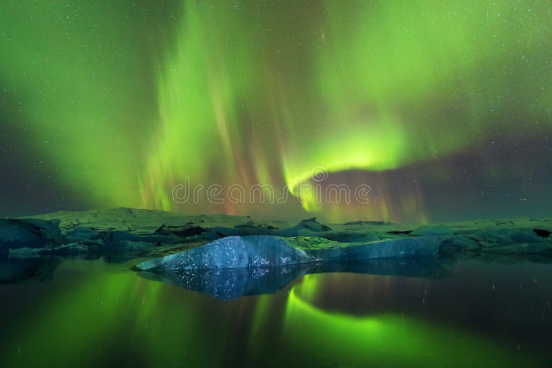 Aurora borealis above the sea. Jokulsarlon glacier lagoon, Iceland. Green northern lights. Starry sky with polar lights.