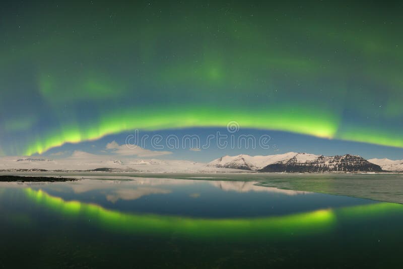 Aurora borealis above the sea. Jokulsarlon glacier lagoon, Iceland. Green northern lights. Starry sky with polar lights.