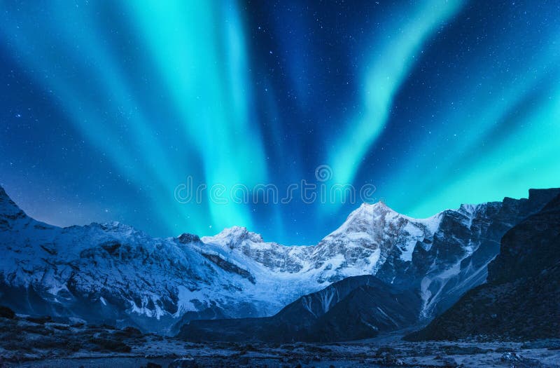 Aurora Borealis Above Snow Covered Mountain Range In Europe Stock Image