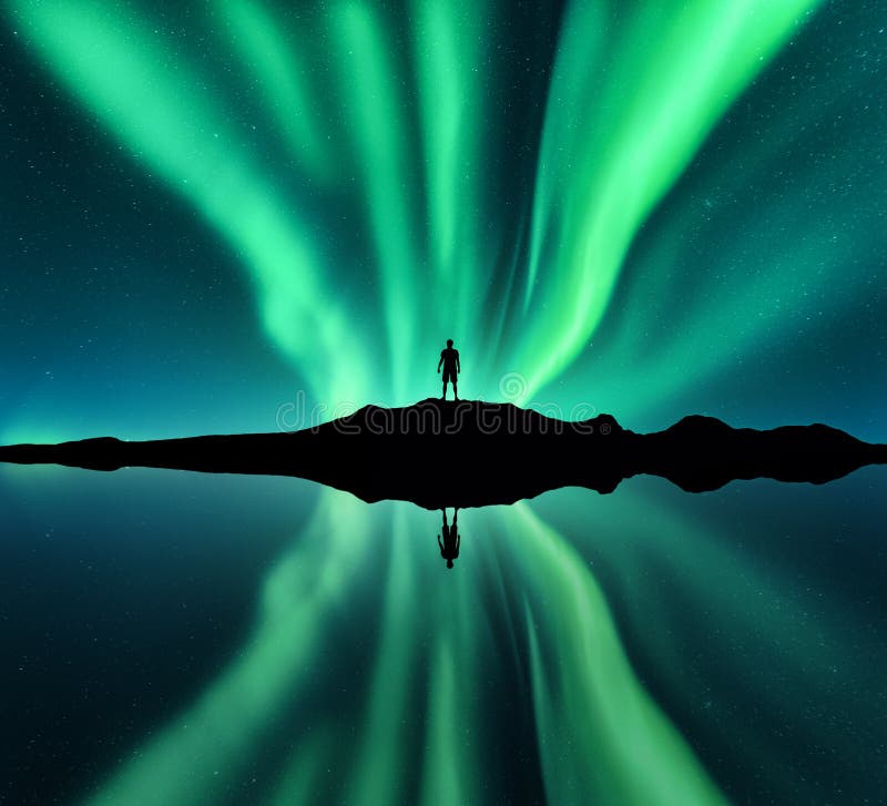 Aurora borealis, man and lake with sky reflection in water