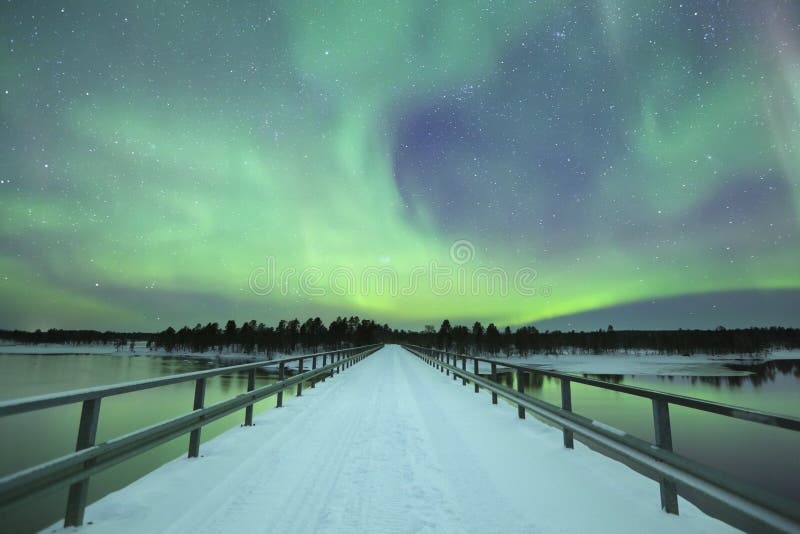 Aurora borealis over a bridge in winter, Finnish Lapland. Spectacular aurora borealis (northern lights) over a bridge and a river in a snowy winter landscape in stock images Aurora borealis over a bridge in winter, Finnish Lapland. Spectacular aurora borealis (northern lights) over a bridge and a river in a snowy winter landscape in stock images