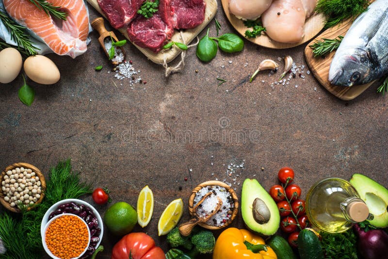 Balanced diet food background. Organic food for healthy nutrition. Meat fish beans and vegetables. Top view copy space on dark stone table. Balanced diet food background. Organic food for healthy nutrition. Meat fish beans and vegetables. Top view copy space on dark stone table.