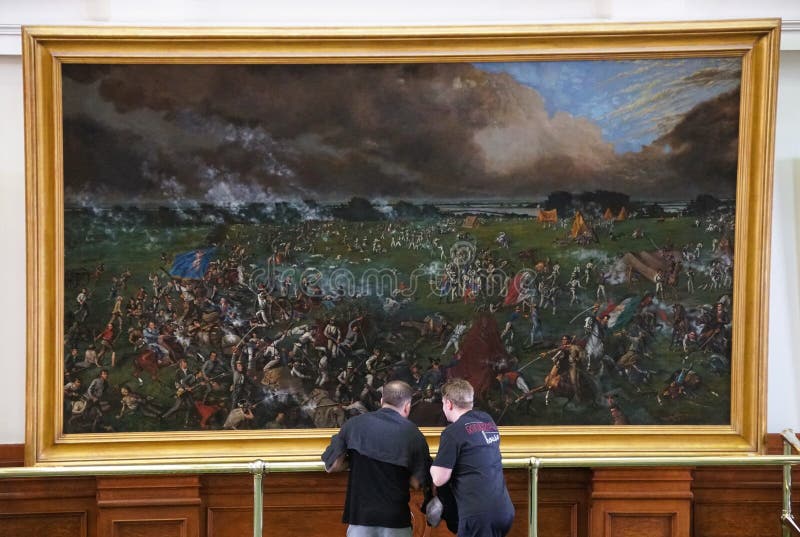 Austin, Texas, U.S.A - April 9, 2024 - Visitors reviewing the painting of The Battle of San Jacinto of 1895 across from the Senate Chamber of the Texas Capitol. Austin, Texas, U.S.A - April 9, 2024 - Visitors reviewing the painting of The Battle of San Jacinto of 1895 across from the Senate Chamber of the Texas Capitol