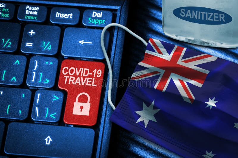 Australia COVID-19 coronavirus travel restrictions concept showing red button warning on keyboard with Australian flag face mask and hand sanitizer. New normal in global travel