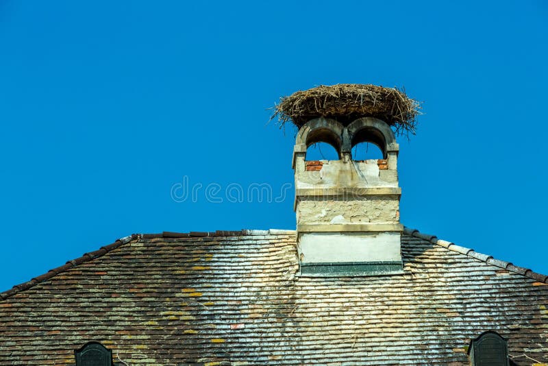 A stork's nest on a achornstein in rust. burgenland, austria. A stork's nest on a achornstein in rust. burgenland, austria