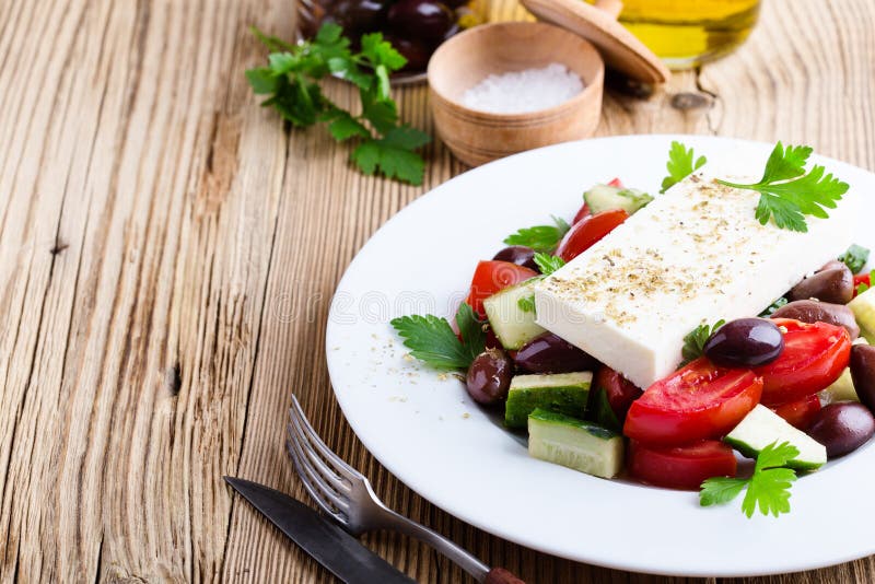 Authentic Greek salad. Easy and delicious traditional dish with fresh, ripe and in season ingredients stock photo Authentic Greek salad. Easy and delicious traditional dish with fresh, ripe and in season ingredients stock photo
