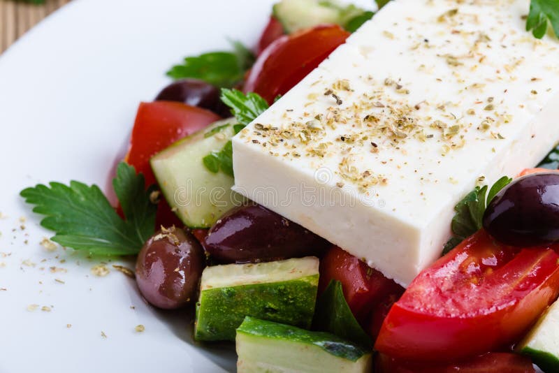 Authentic Greek salad. Easy and delicious traditional dish with fresh, ripe and in season ingredients stock image Authentic Greek salad. Easy and delicious traditional dish with fresh, ripe and in season ingredients stock image