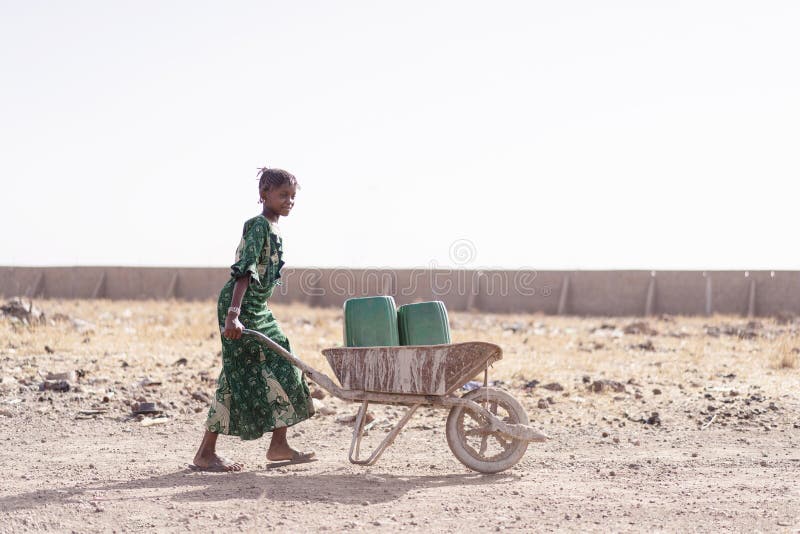 Authentic Native African Girl Carrying Fresh Water for lack of water symbol royalty free stock photo